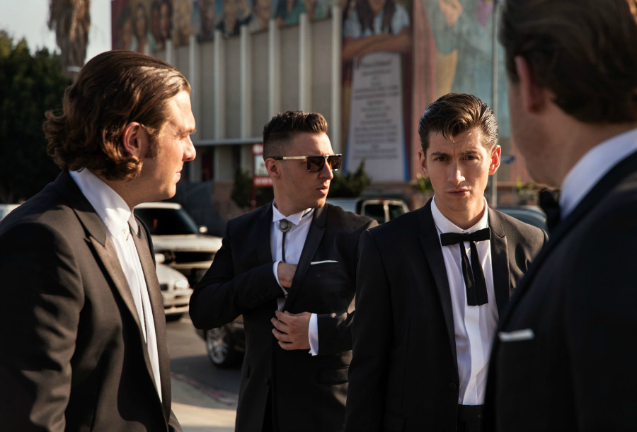 Arctic Monkeys con trajes negros en la calle