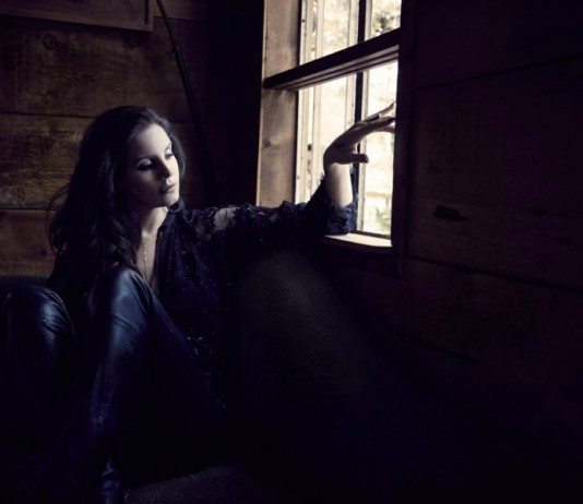 Lana Del Rey en la ventana de una habitación a oscuras